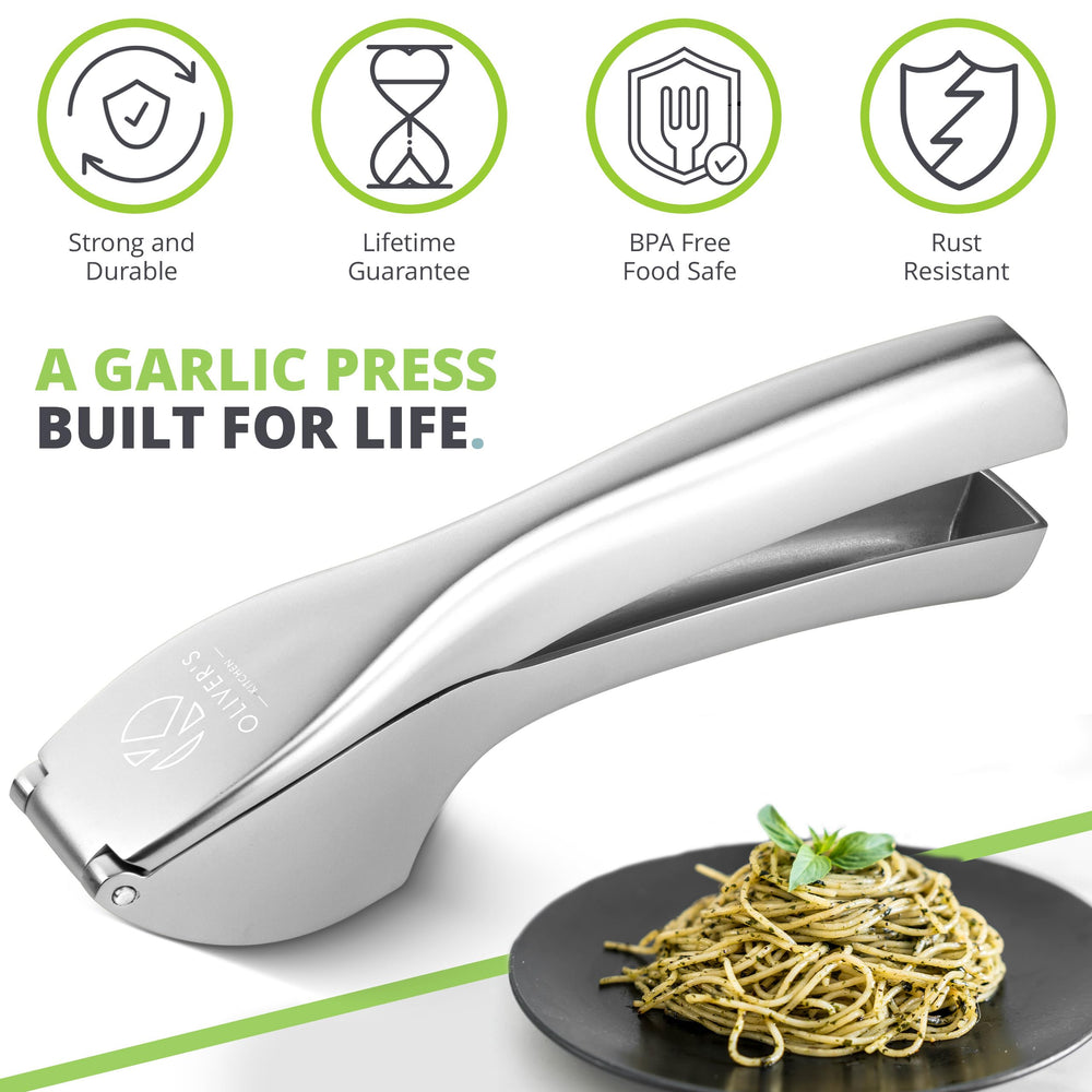 Garlic press for life - sturdy silver garlic crusher next to a bowl of garlic pasta