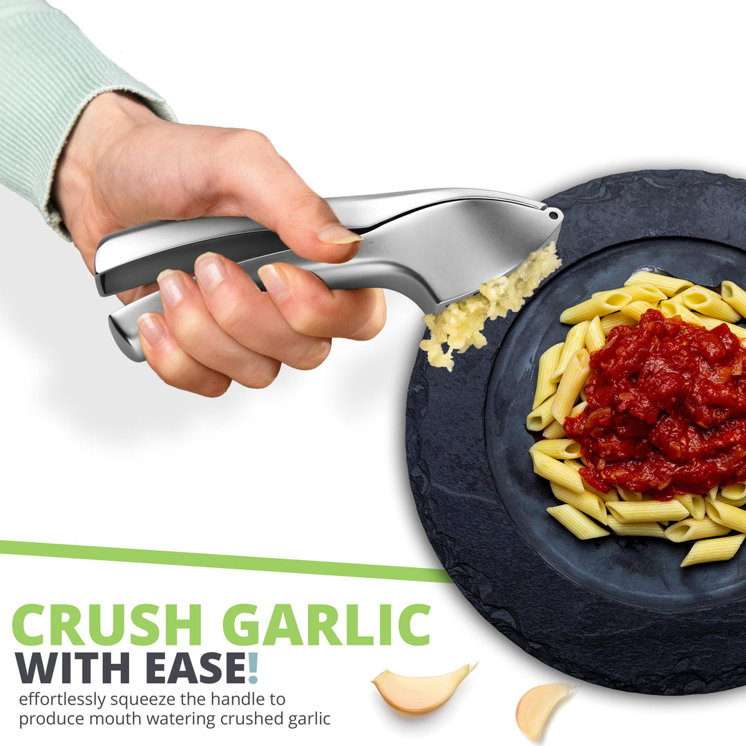 Crush garlic with ease - garlic press squeezing fresh garlic over a bowl of pasta